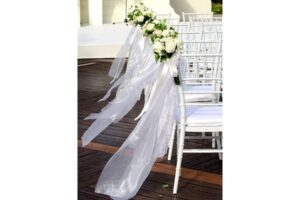 Flower bouquets attached to chairs